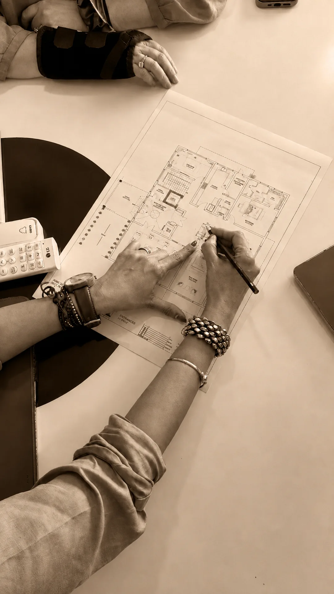 Sonia Gehlot at the drawing board, reviewing a floor plan
